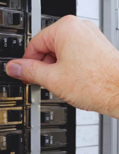 Homeowner flipping circuit breaker after it tripped from appliance