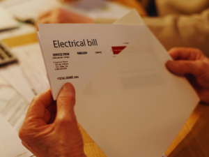 Homeowner opening electrical bill 