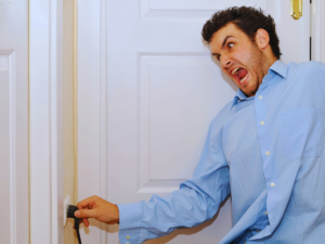 Man getting shocked by improperly grounded outlet 