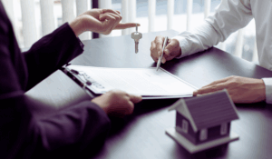 real estate agent handing to keys to recent home buyer