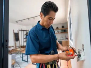 Right Touch Electrical technician using multimeter to troubleshoot wall outlet